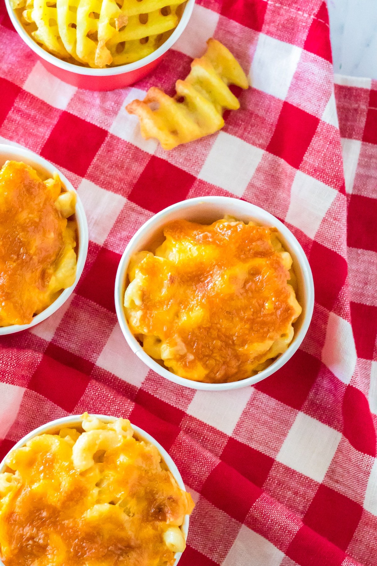 Overhead of the Chick-fil-A Mac and Cheese Recipe in red cups with fries.