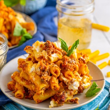 Plated Easy Baked Ziti Recipe on plate with glass of tea in background.