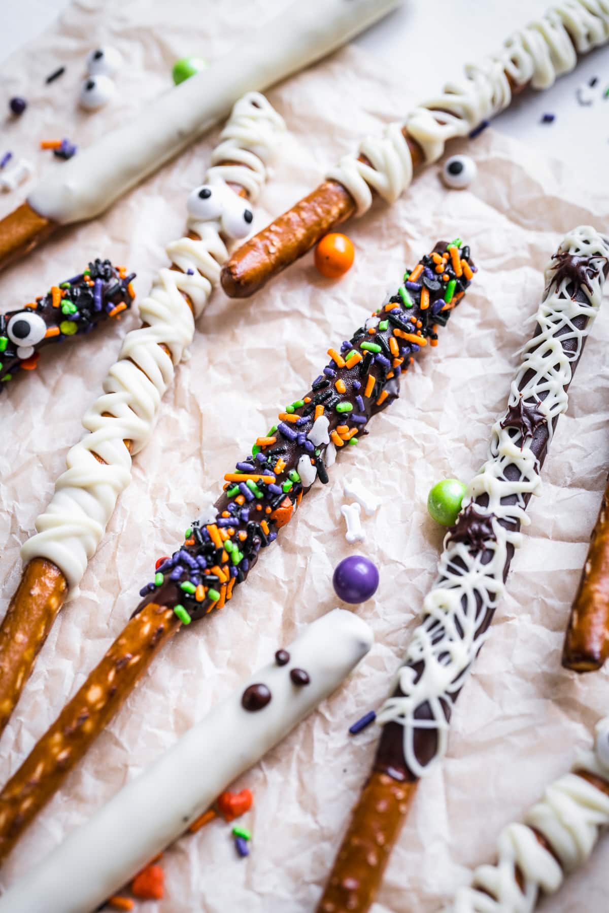 Close up of Halloween Chocolate Pretzel Rods on parchment paper.