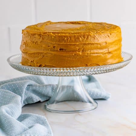 Finished Homemade Caramel Cake on cake stand.