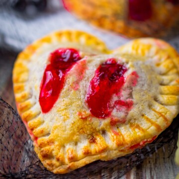 Close up of one of the Vampire Kiss Strawberry Hand Pies with the filling coming out of the holes.