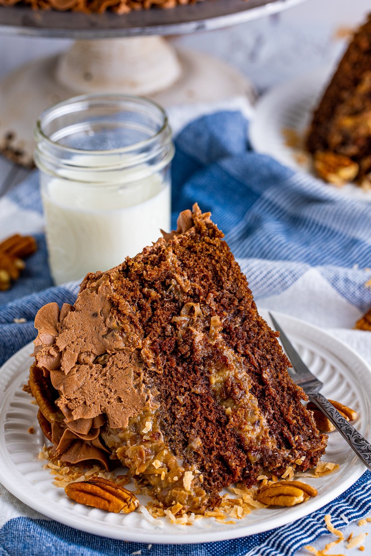 Close up of slice of the German Chocolate Cake Recipe showing the filling and topping.