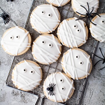 Overhead of Mummy Cookies on metal tray with spiders.