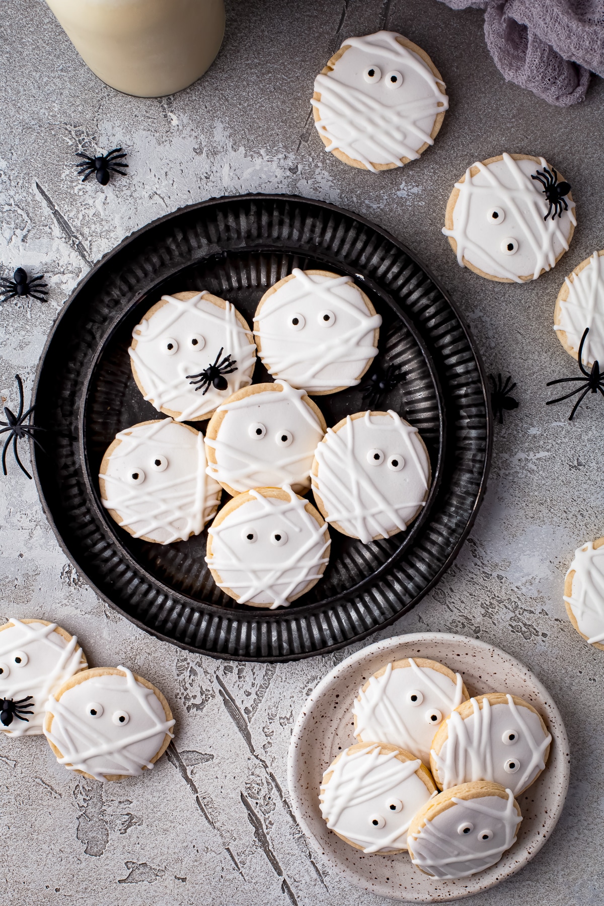 Cookies on black and white plates overhead.
