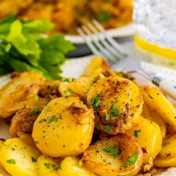 Close up of plate with Smothered Potatoes on it with fork.