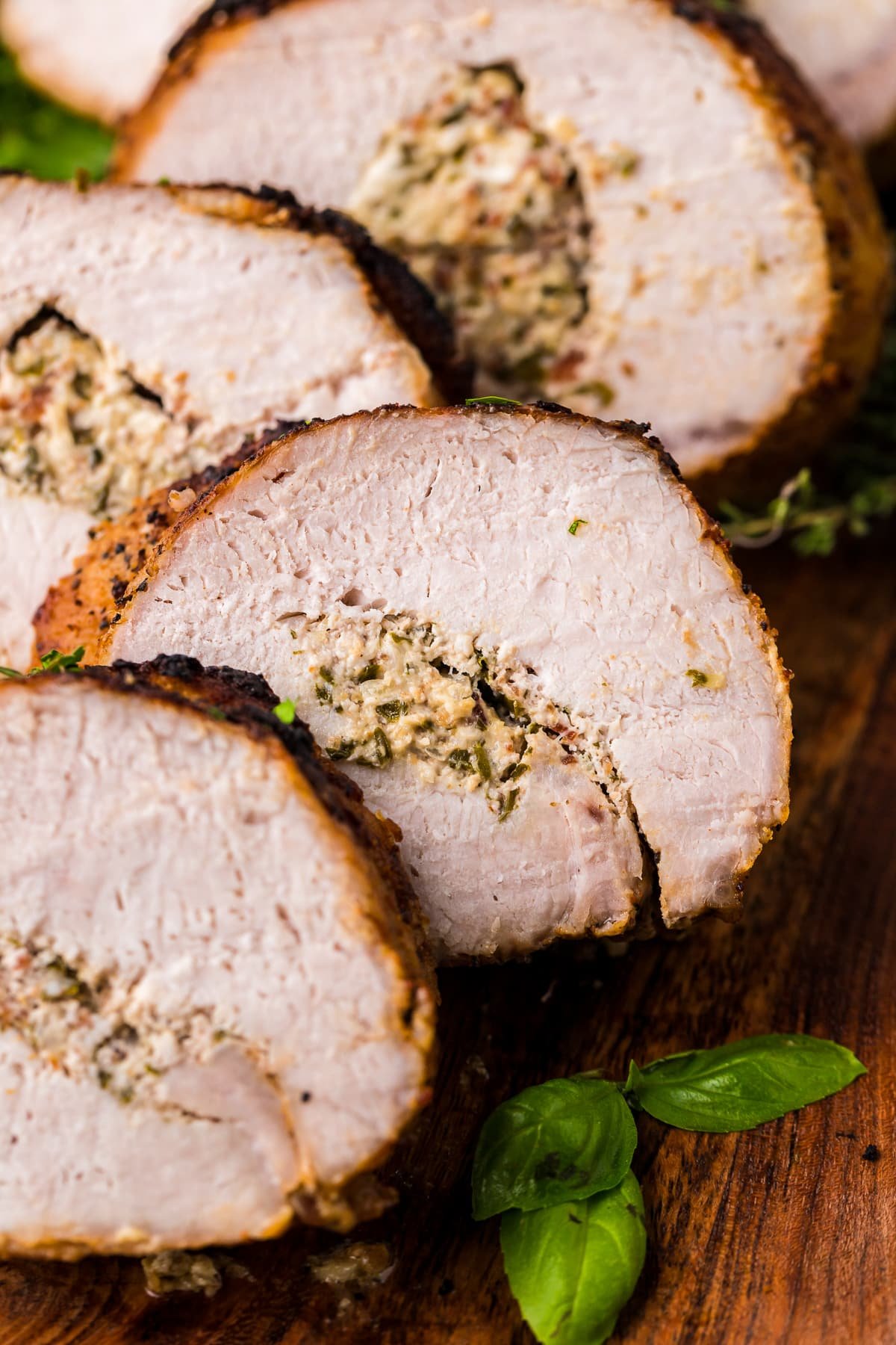Slices of cut Stuffed Pork Loin leaning against one another.