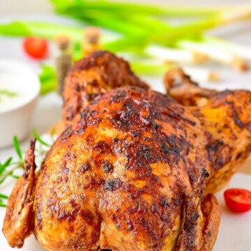 Finished Whole Roasted Chicken uncut on serving platter.