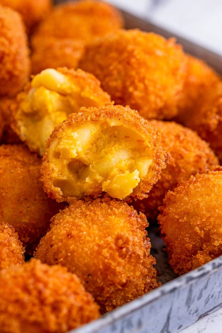 Close up of one opened Fried Mac and Cheese stacked on metal tray.