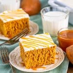 Top slices of Sweet Potato Cake on plates with caramel sauce and milk in background.