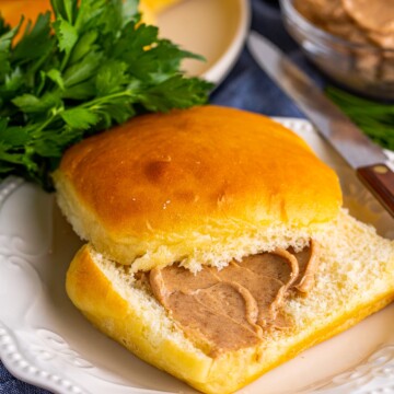 On roll on plate cut in half and spread with cinnamon butter.