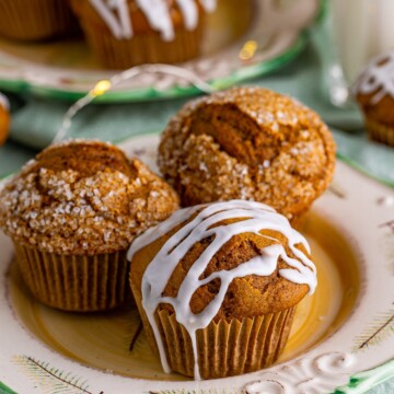 Three Gingerbread Muffins on a Christmas plate, one glazed and two sugared.