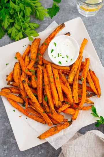 A plate of crispy oven sweet potato fries with dipping sauce