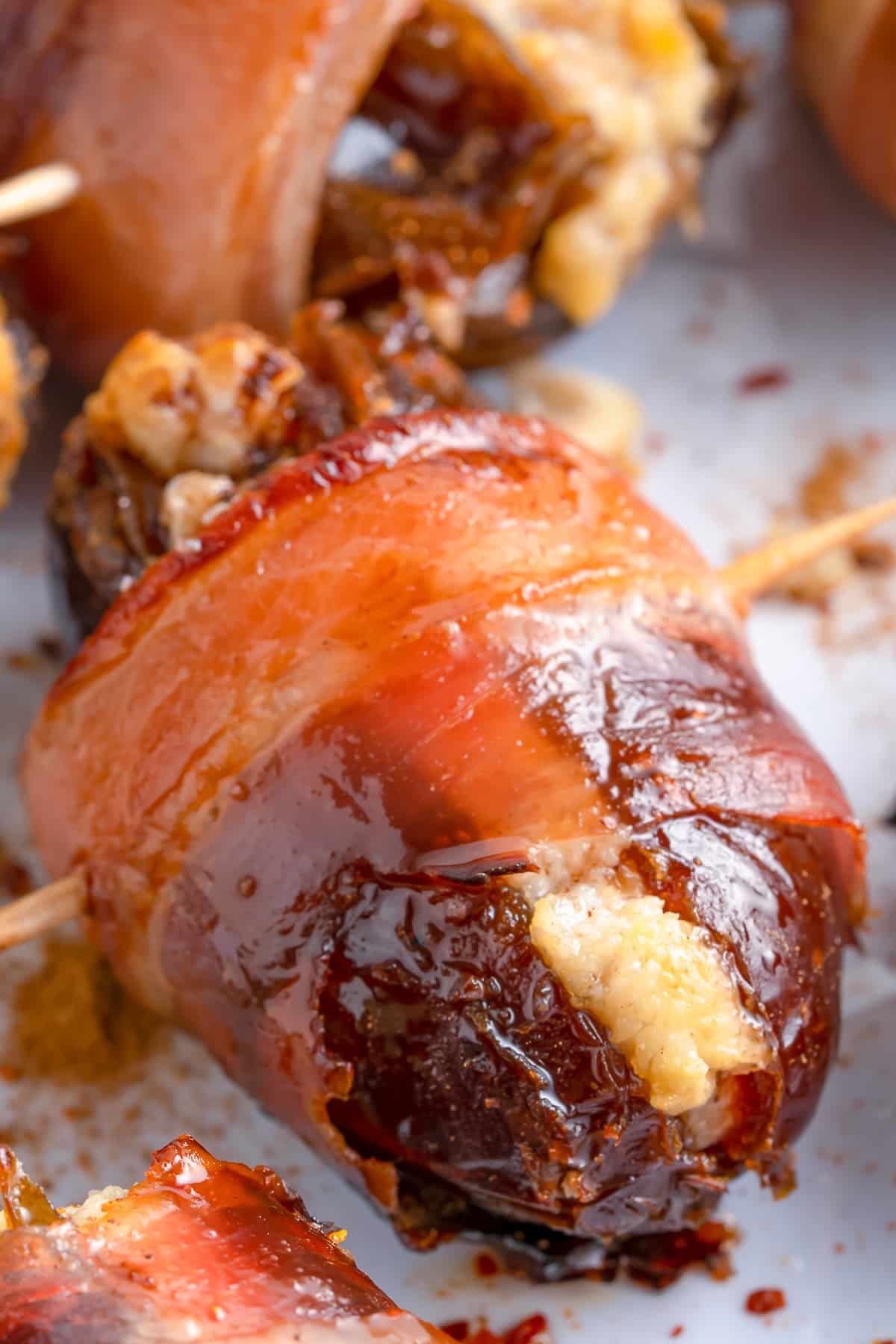Close up of one of the dates showing browned bacon and creamy filling.