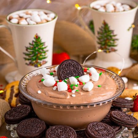 Hot Chocolate Dip in bowl garnished with hot chocolate in background.