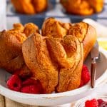 Close up of Popover Recipe in white dish with fruit in dish.