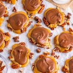 Overhead of Turtle Candy on parchment paper with pecans.