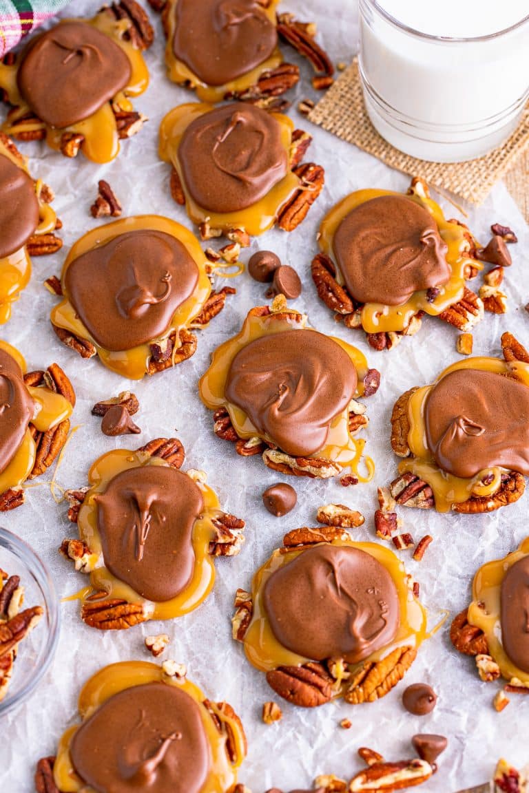 Overhead of Turtle Candy on parchment paper with pecans.