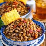 Finished Bacon Black Eyed Peas in bowls with cornbread.