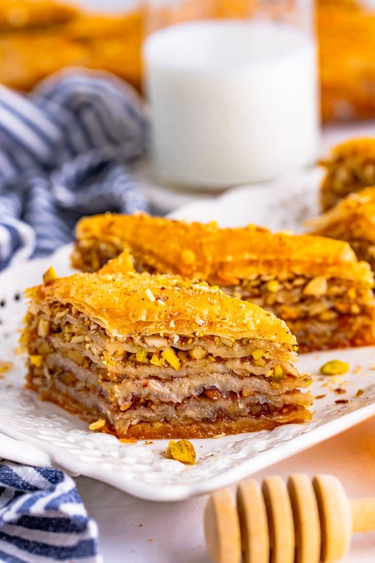 Slice of Easy Baklava Recipe on white serving platter to show layers.