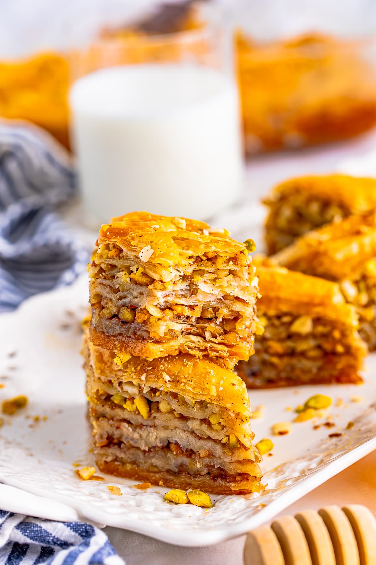 Two slices of Easy Baklava Recipe stacked on top of each other with a bite taken out.
