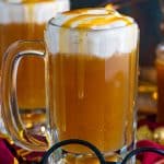 Close up of one glass of the Butterbeer Recipe with glasses in front.
