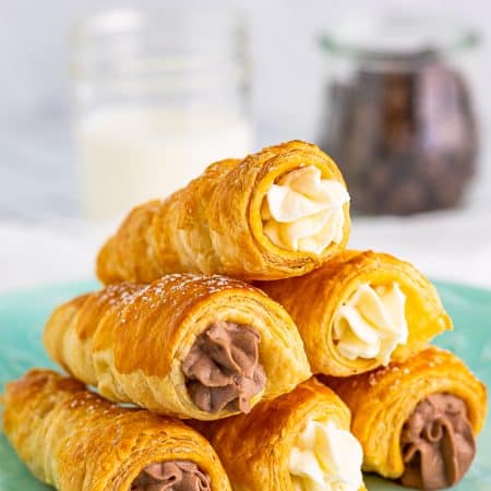 Stacked Cream Horns on turquoise plate.