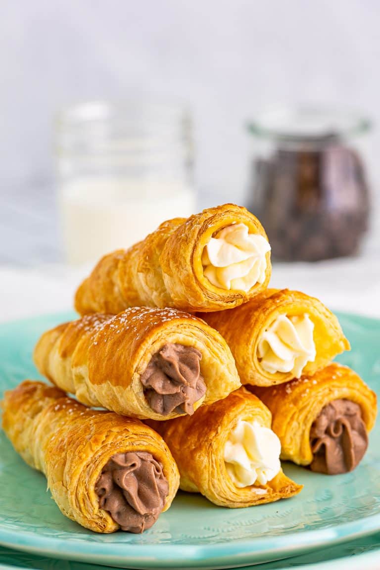 Stacked Cream Horns on turquoise plate.
