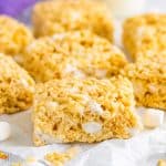 Rice Krispies Treats Recipe finished and cut into bars on parchment paper.