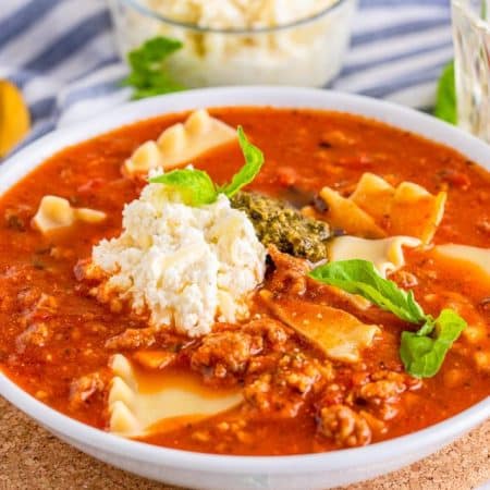 Bowl of the Lasagna Soup Recipe with garnishes on top.