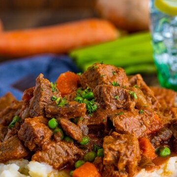 Close up of Easy Beef Stew on plate over mashed potatoes.