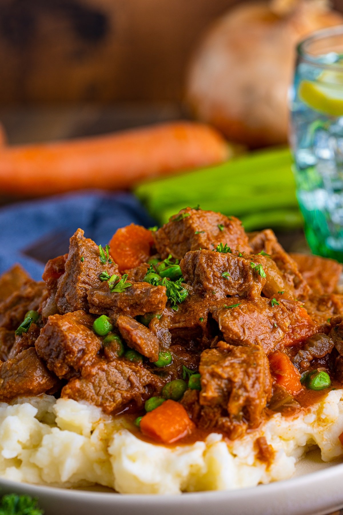 Close up of Easy Beef Stew on plate over mashed potatoes.