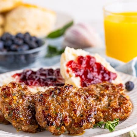 Homemade Breakfast Sausage on plate with biscuits with jam.