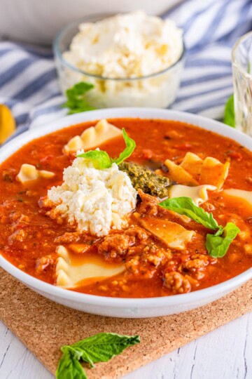 Bowl of the Lasagna Soup Recipe with garnishes on top.