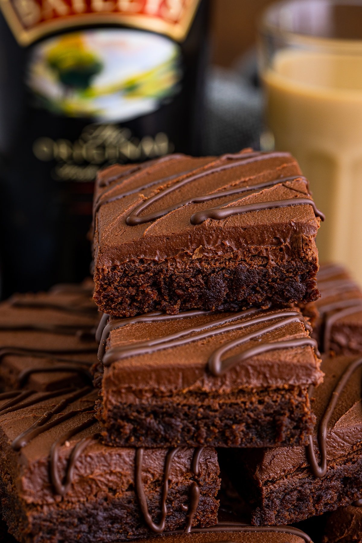 A stacked platter of Bailey's Brownies with more Irish cream and bottle in the background