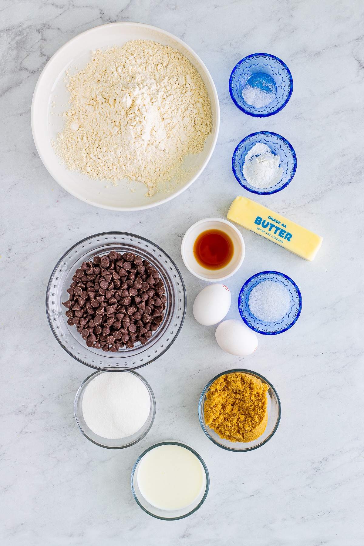 Overhead shot of ingredients needed to make Easy Chocolate Chip Muffins on a grey marble table top