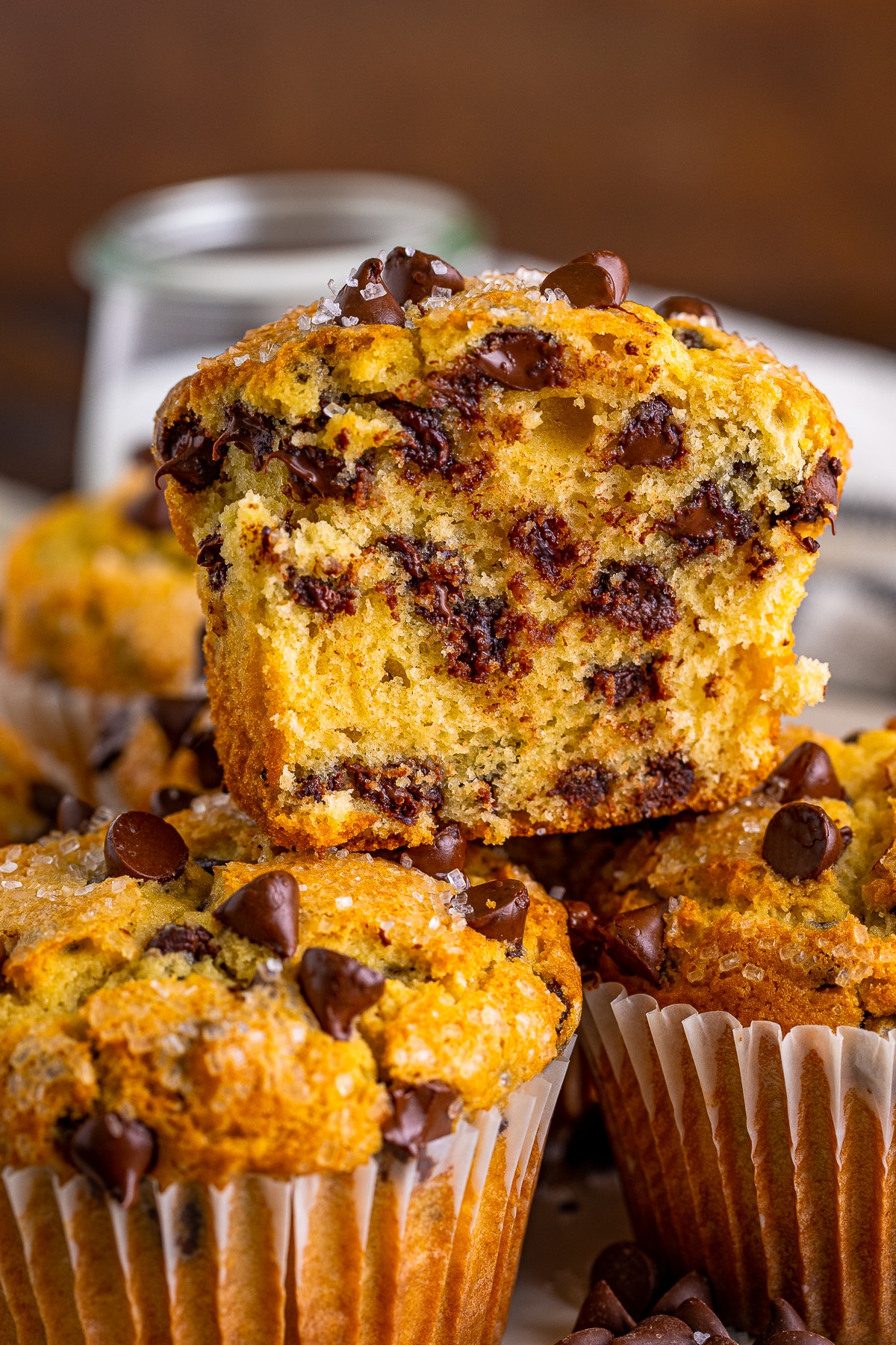 Stack of Easy Chocolate Chip Muffins showing an entire section of one muffin with dark brown background