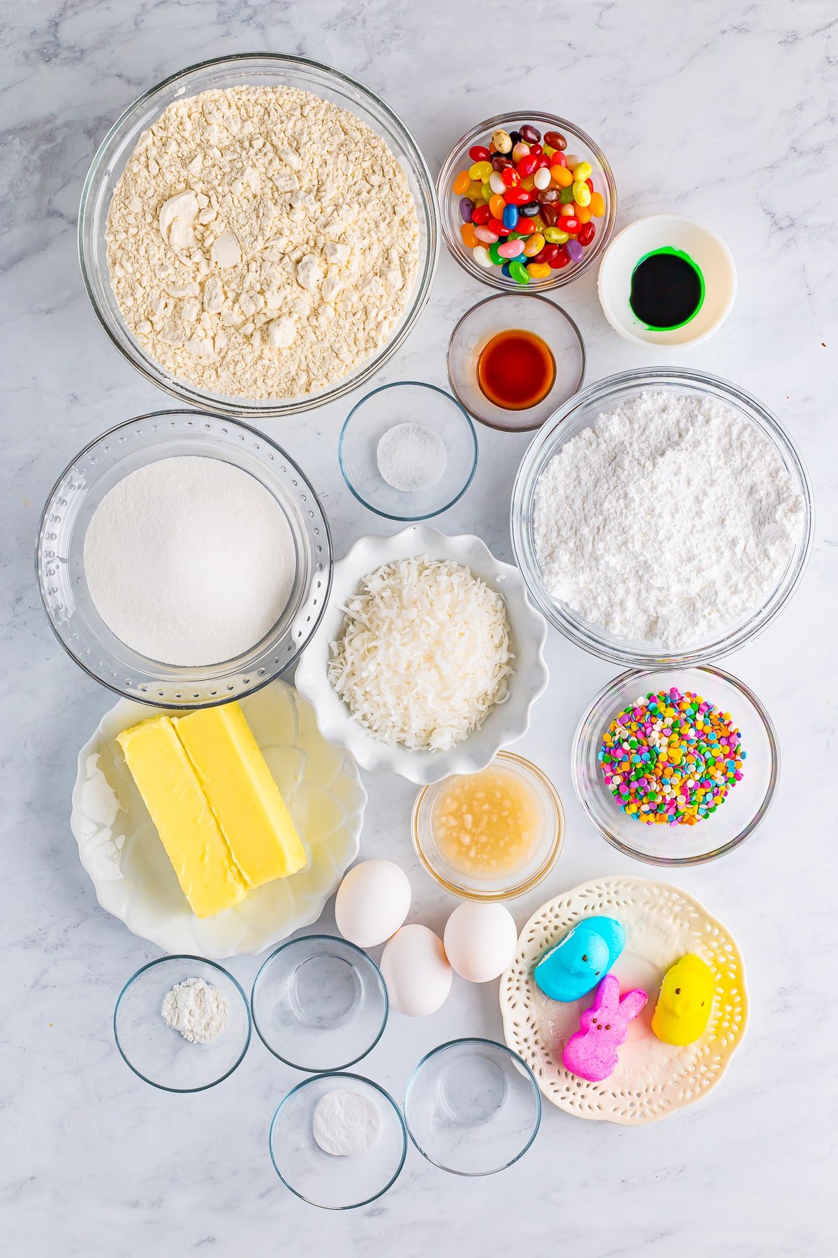 Overhead image of ingredients needed to make easter cookie bars on a grey marble table top