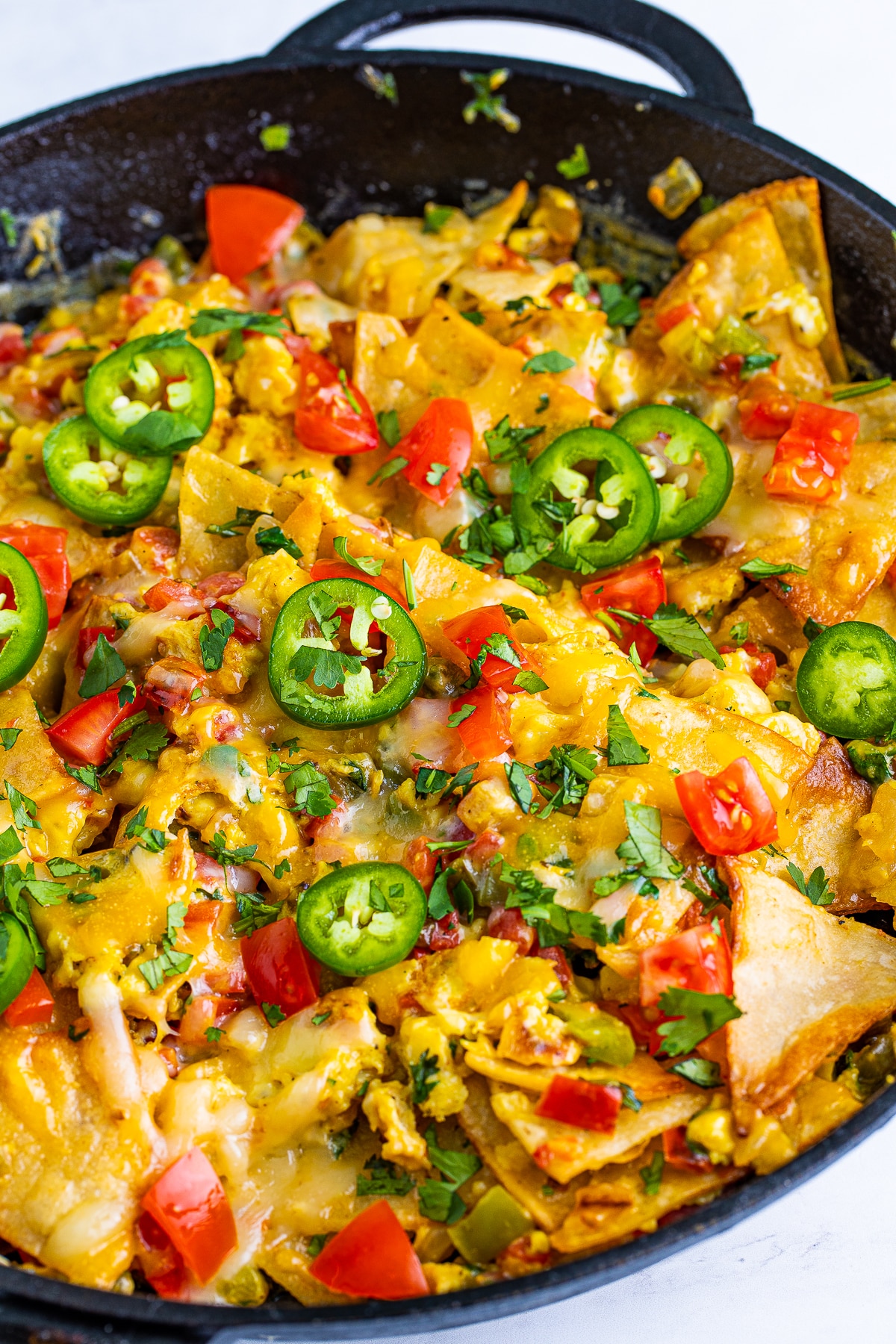 Migas Breakfast with toppings in a cast iron skillet