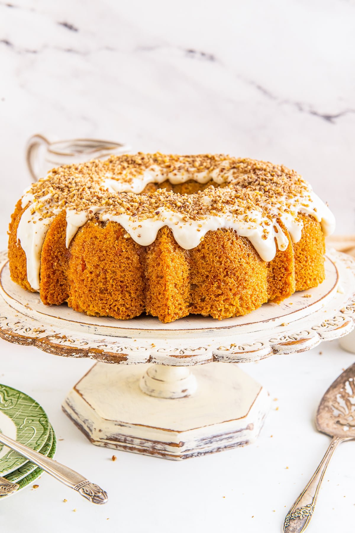Carrot bundt cake on a ivory wooden cake stand