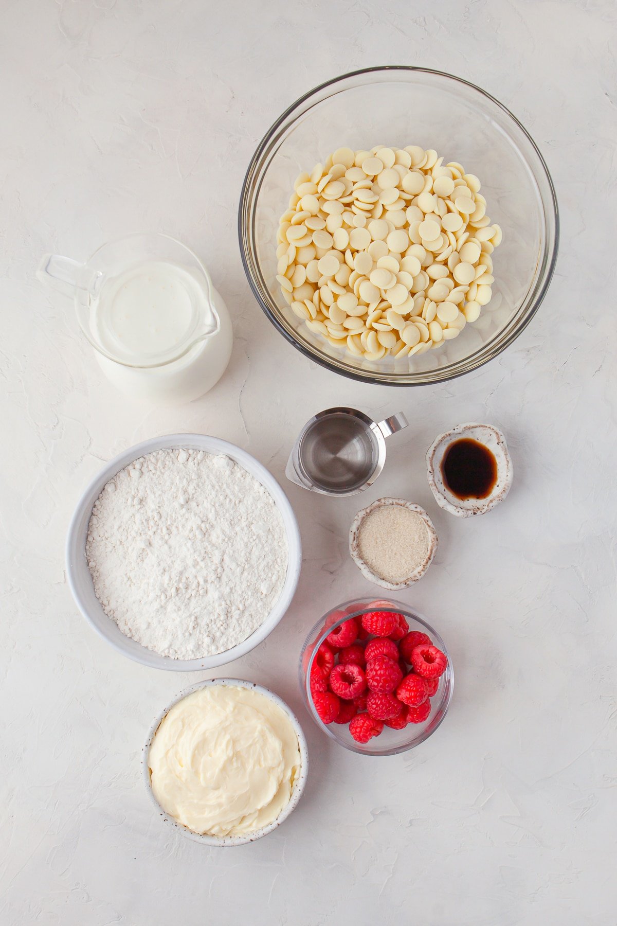 Overhead image of ingredients needed to make Raspberry Tart on a white stucco counter top