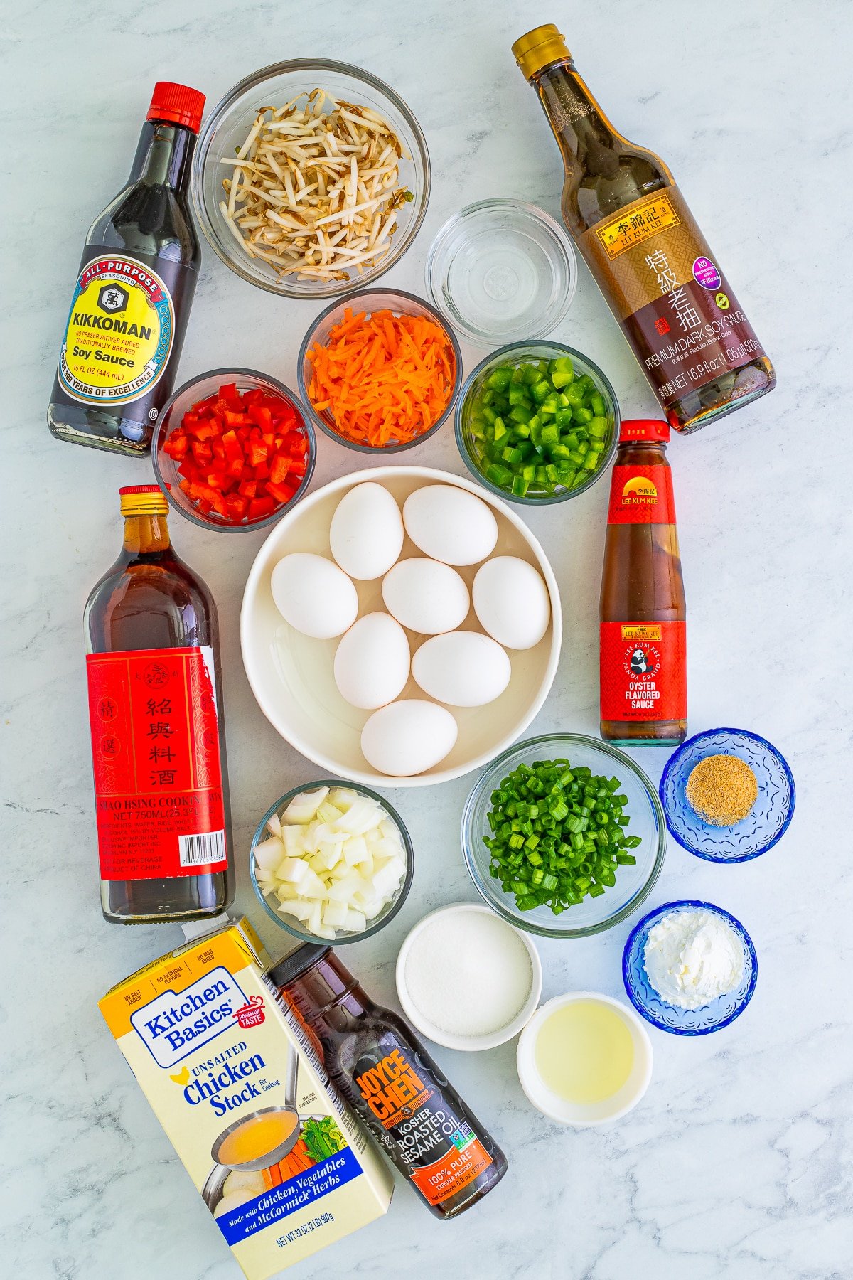 Overhead shot of ingredients needed to make Vegetable Egg Foo Young Recipe on a gray marble tabletop.