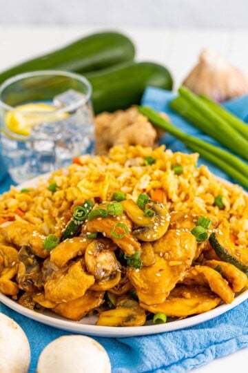 Copycat Panda Express Mushroom Chicken with zucchini and mushrooms on a blue plate.