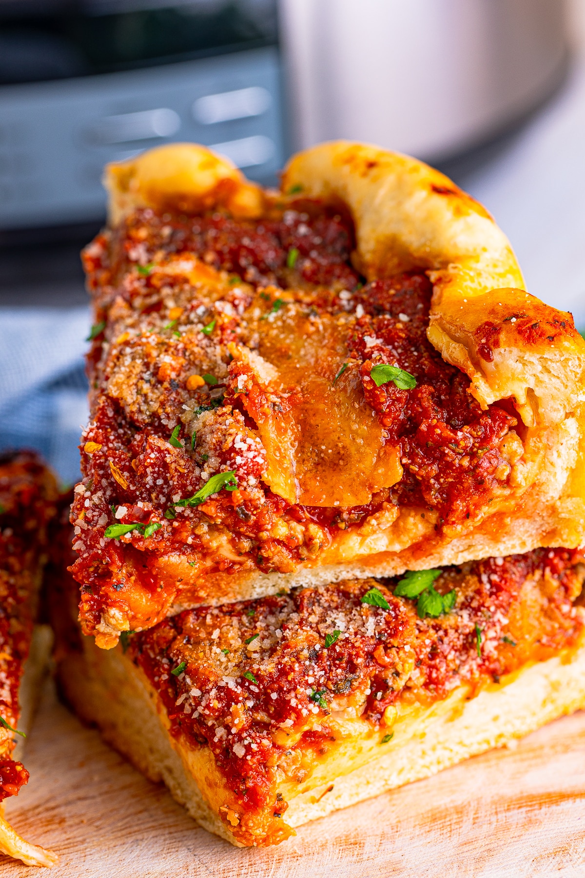 Two slices of slow cooker deep-dish pizza stacked on top of each other