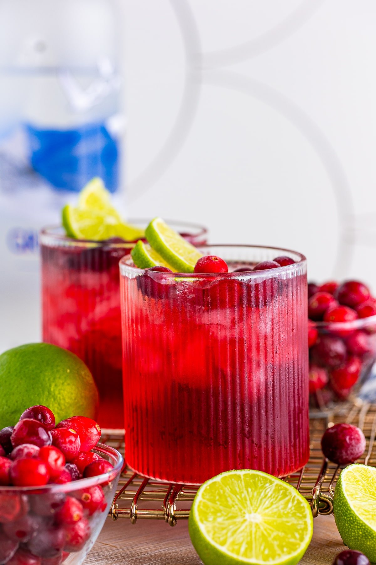 Straight on image of vodka cranberry cocktail on a wire serving platter