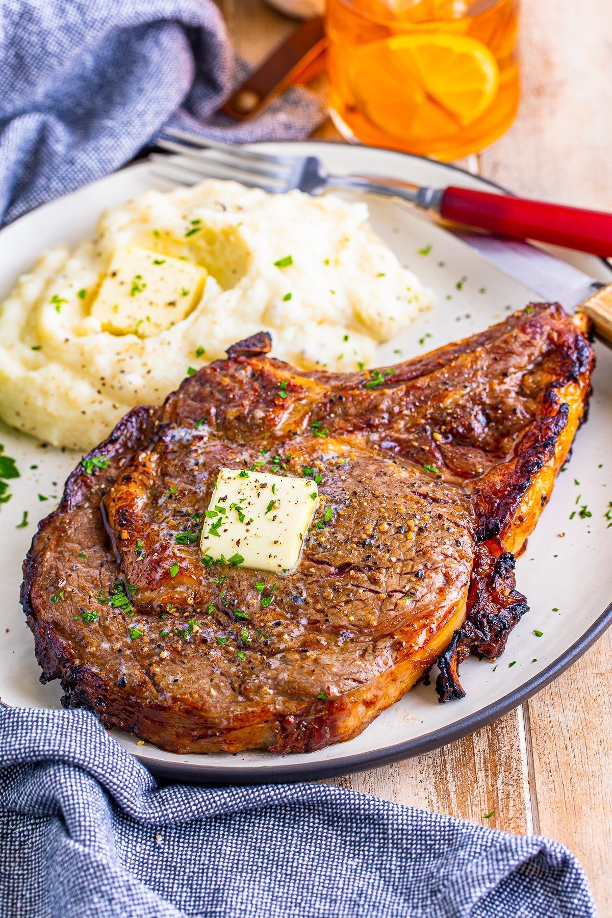 air fryer ribeye steak on a tan plate with mashed potatoes