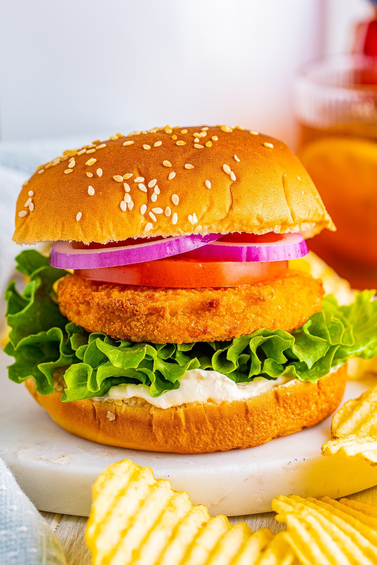 Straight on image of air fryer frozen chicken patties dressed up as a chicken burger