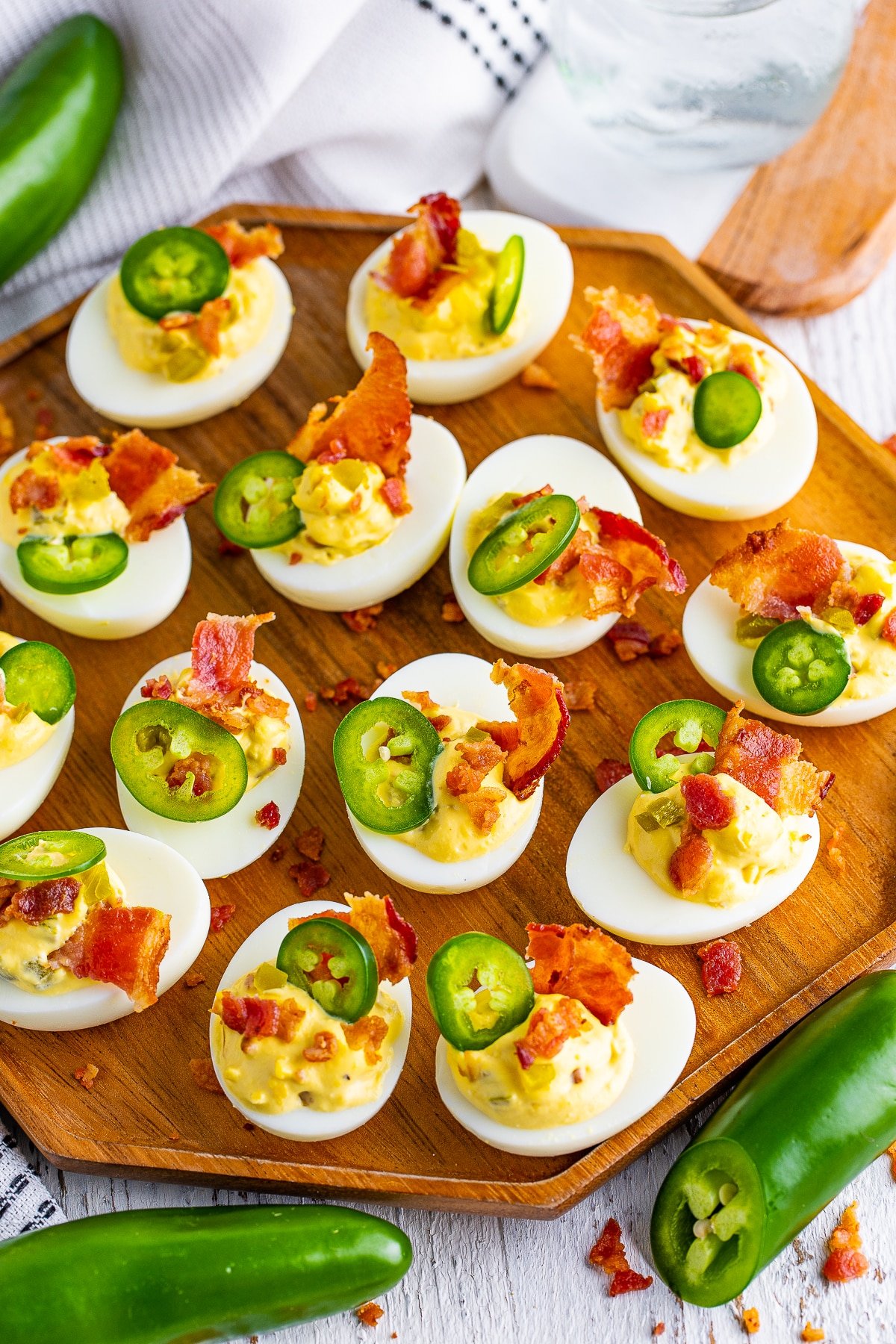Overhead image of jalapeno deviled eggs on a wooden serving tray