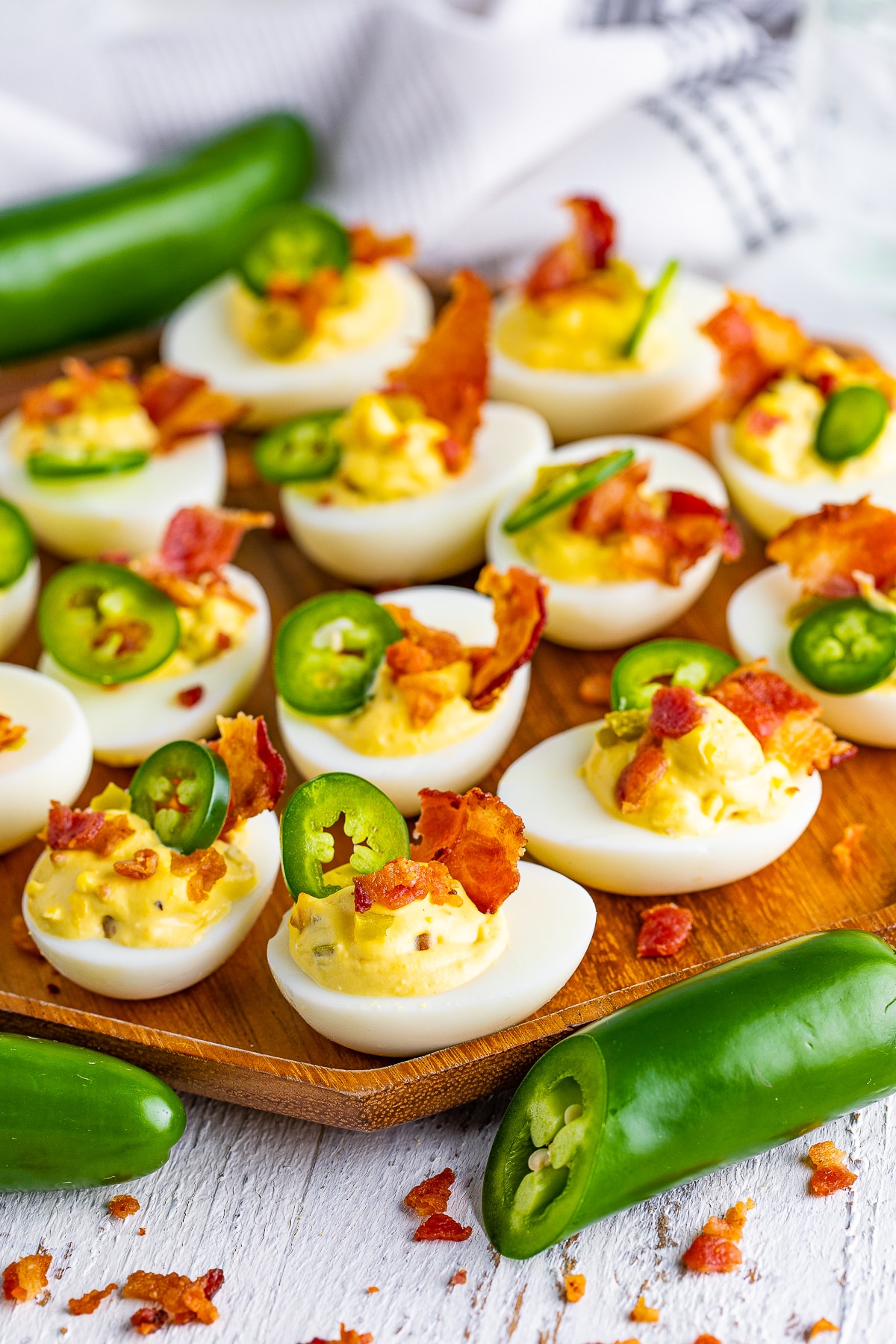 jalapeno deviled eggs on a wooden plate