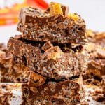 A stack of homemade Nestle crunch bars topped with chopped Kit Kats.