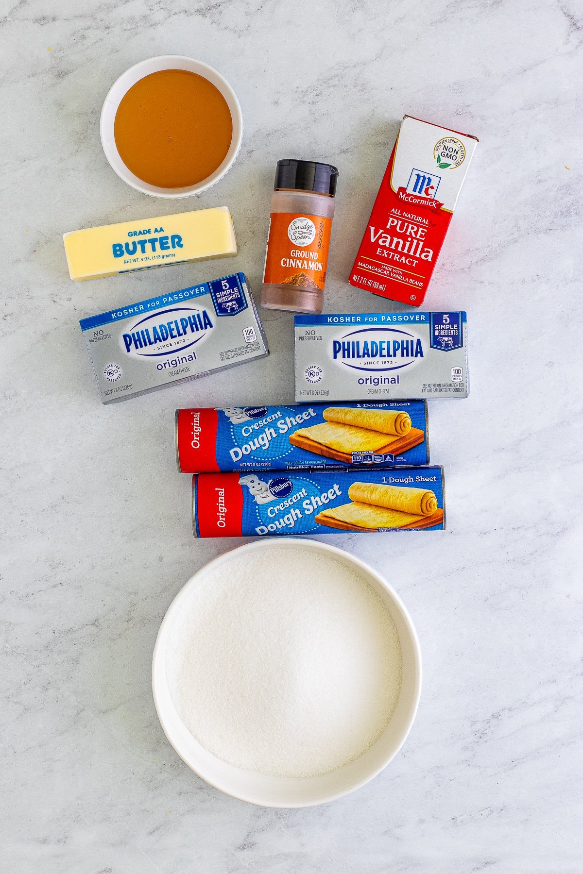 Overhead image of ingredients needed to make sopapilla cheesecake bars recipe on a grey marble table top